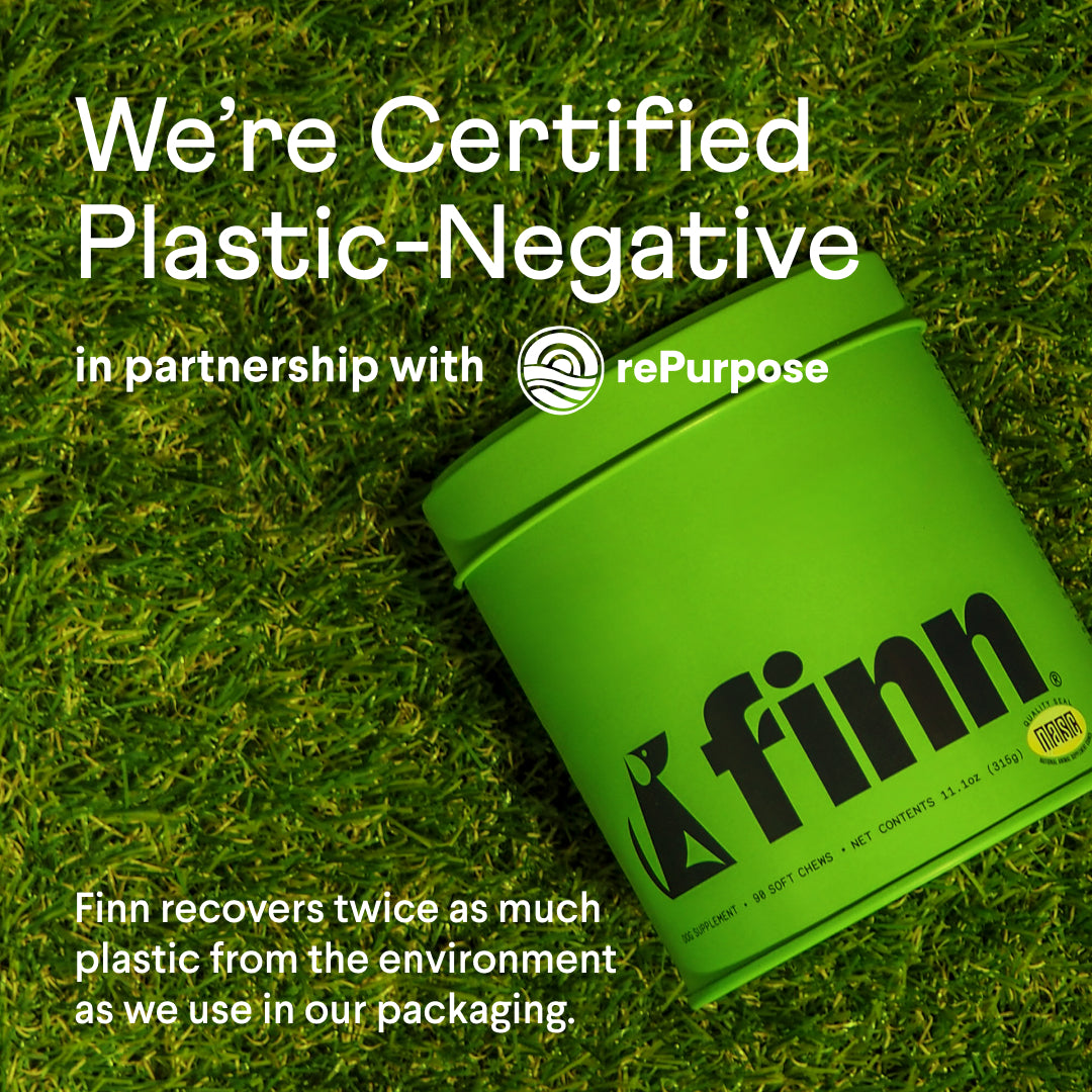 Green Finn chewing tobacco container on grass background with "We're Certified Plastic-Negative" sustainability messaging