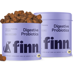 Two purple containers of Finn Digestive Probiotics dog supplements with brown soft chews scattered beside them