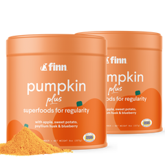 Two orange containers of Finn Pumpkin Plus superfood powder for regularity, with pumpkin graphics and yellow powder visible