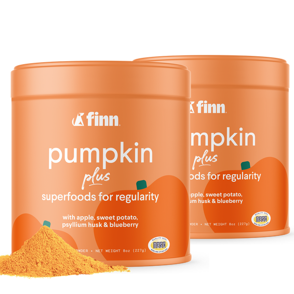 Two orange containers of Finn Pumpkin Plus superfood powder for regularity, with pumpkin graphics and yellow powder visible