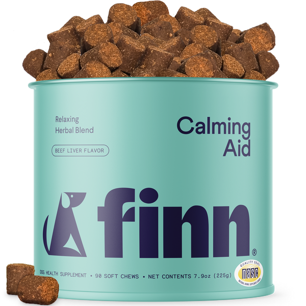 Finn Calming Aid supplement can with dog treats on a white background