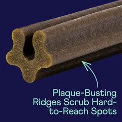 Brown dog dental chew with textured ridges against blue background, highlighting plaque-busting design for hard-to-reach areas