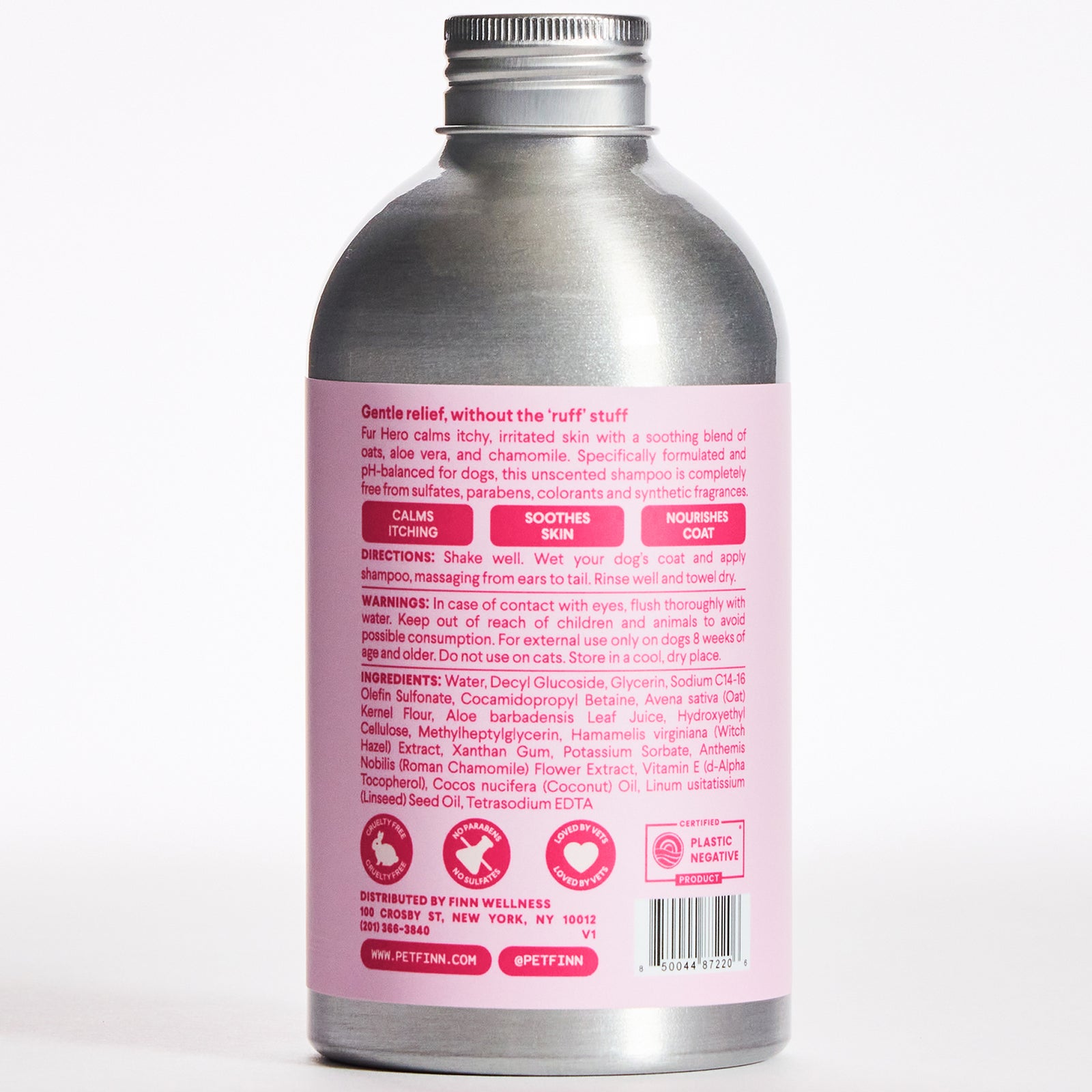 Silver aluminum bottle with pink label showing dog shampoo product information and ingredients on back panel