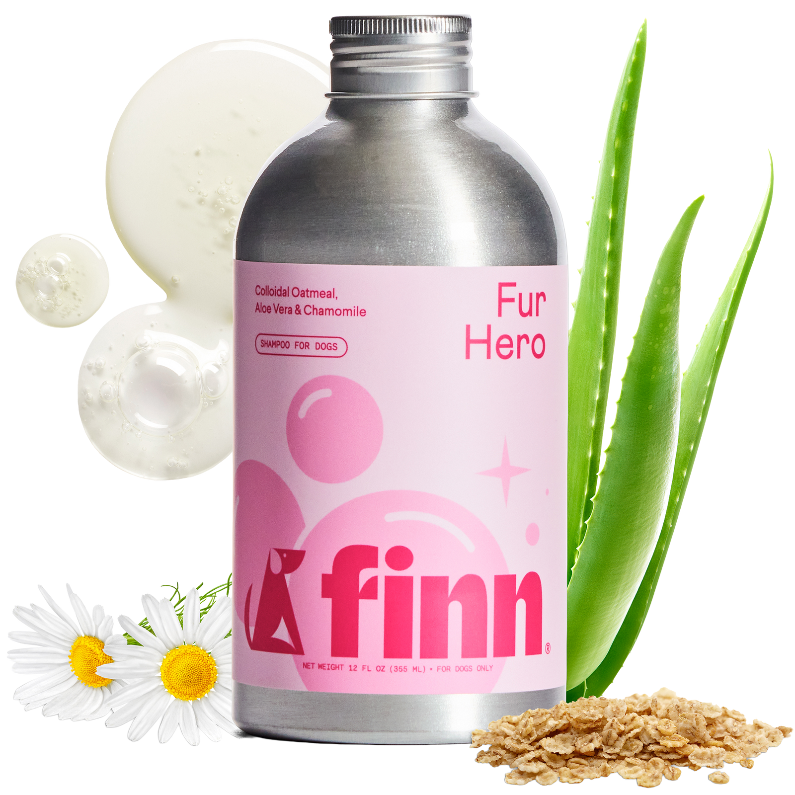 Pink-labeled Finn Fur Hero dog shampoo bottle with silver cap, surrounded by aloe vera leaves, chamomile daisies, cucumber slices, and oats on black background.