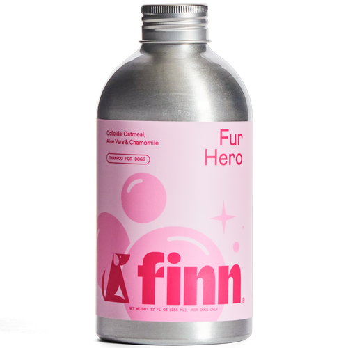 Silver aluminum bottle of Finn Fur Hero dog shampoo with pink label featuring colloidal oatmeal, aloe vera and chamomile