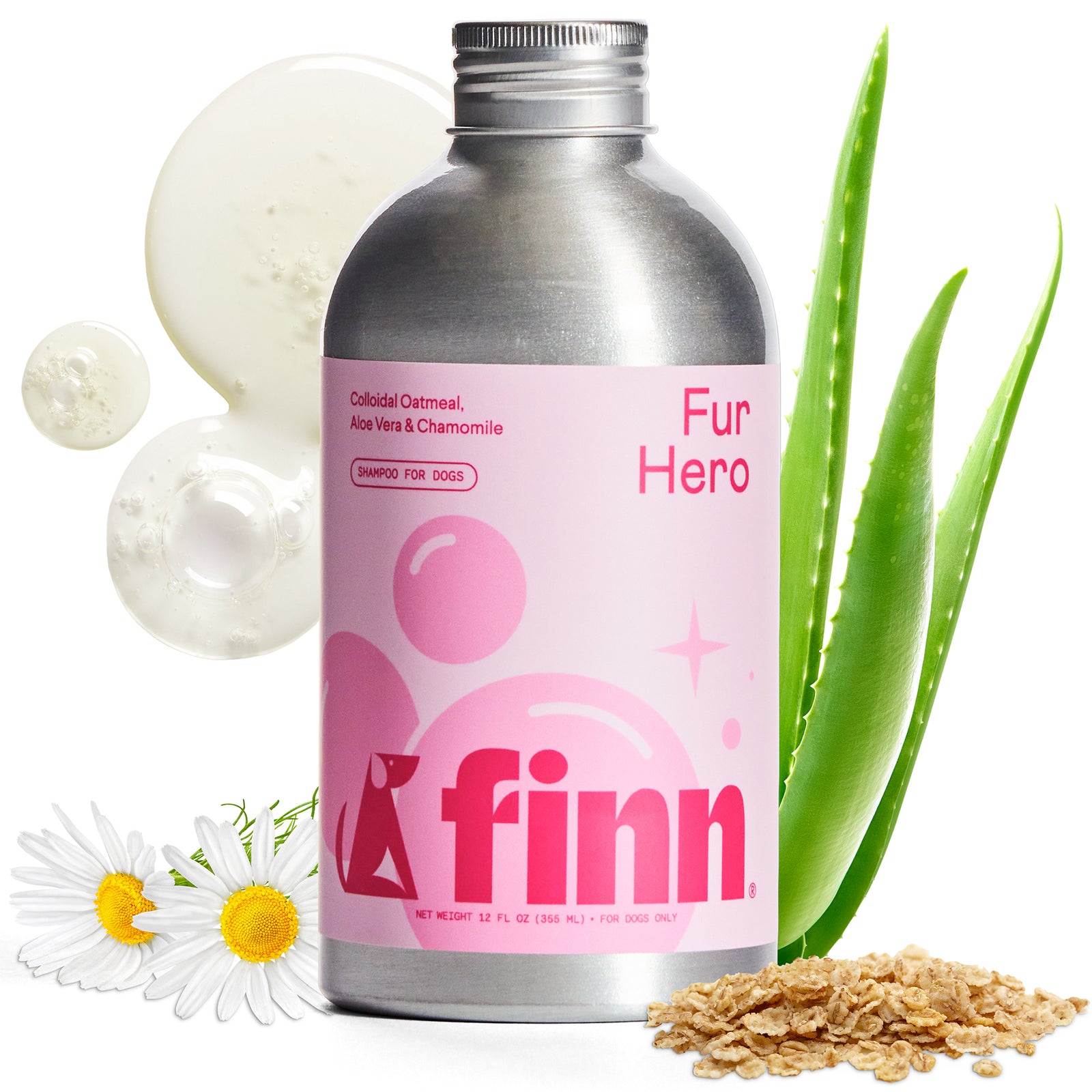 Pink Finn Fur Hero dog shampoo bottle with silver cap surrounded by natural ingredients: oatmeal, aloe vera plant, and chamomile flowers