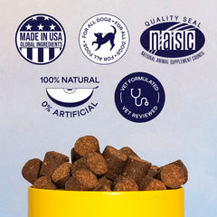 Bowl of brown dog food kibble with quality certification badges including Made in USA, NASC seal, 100% Natural, and Vet Formulated logos above