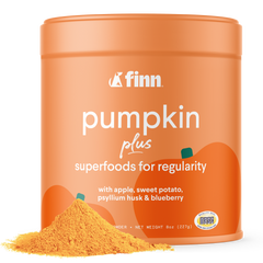 Orange cylindrical container of Finn pumpkin plus superfood powder with product spilled in front, black background