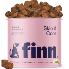 Pink canister of Finn Skin & Coat dog food with dog treats on a white background