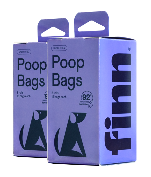 Two purple boxes of unscented poop bags, each containing 8 rolls with 15 bags, featuring green dog silhouettes and made from 92% plant-based materials.