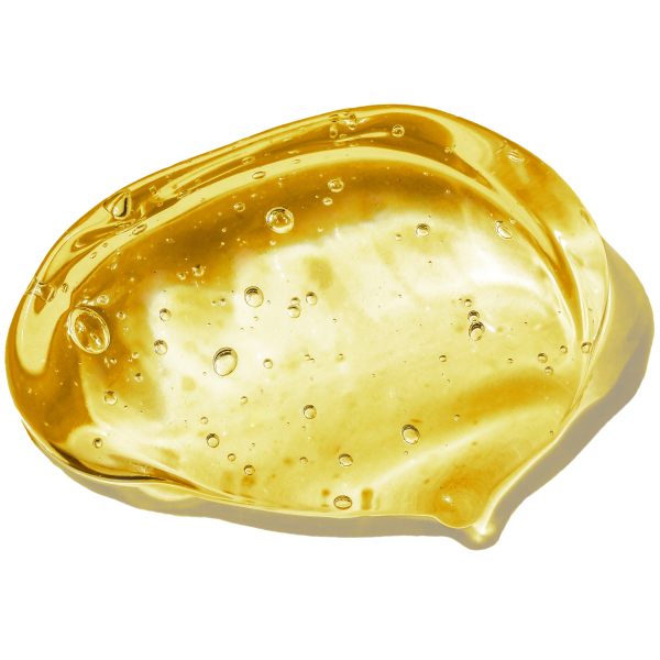 Golden, translucent gel capsule or oil drop with small air bubbles suspended throughout