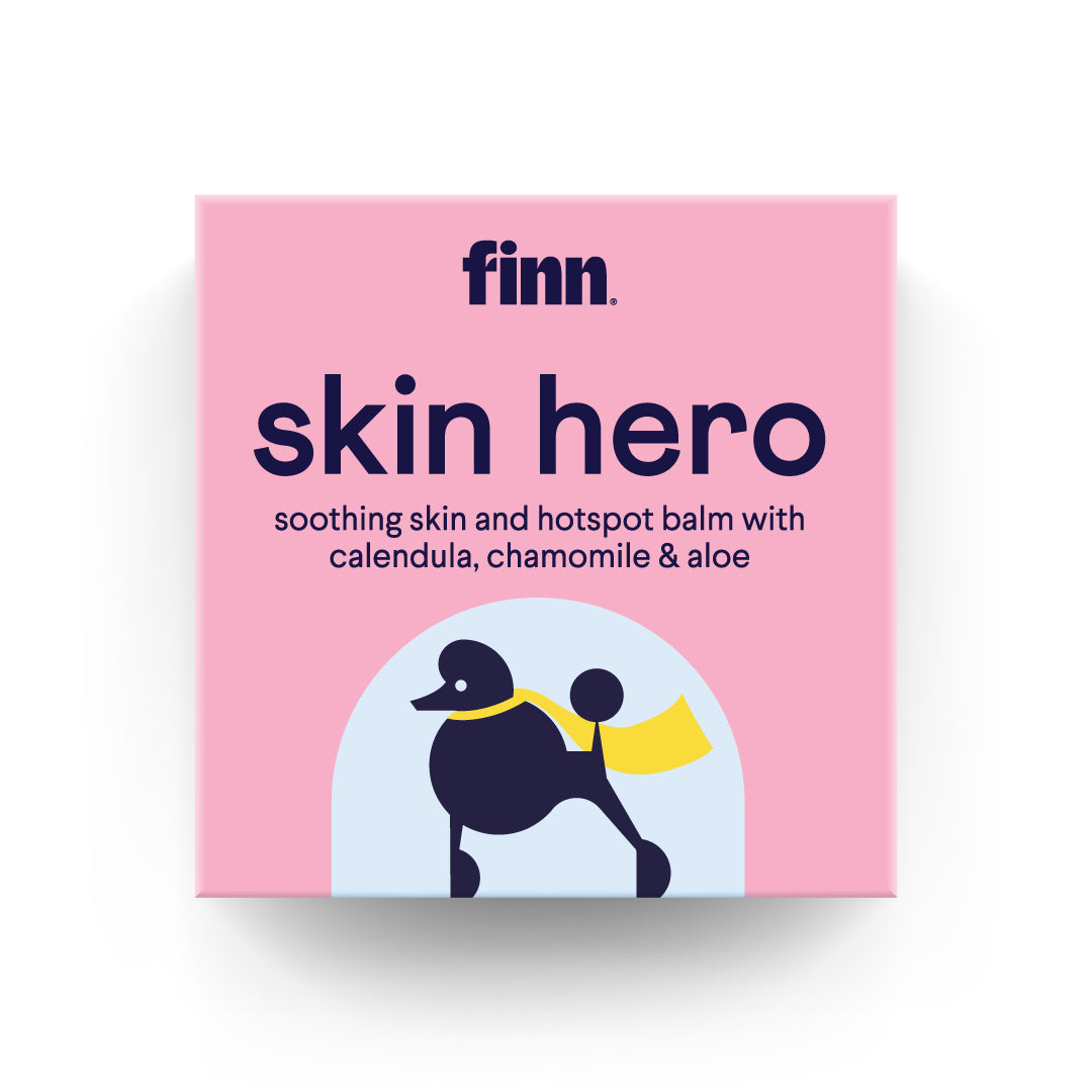 Pink box of Finn Skin Hero soothing balm with calendula, chamomile & aloe, featuring black poodle illustration with yellow cape