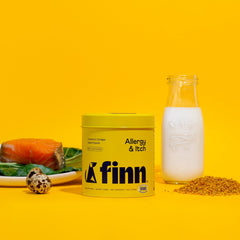 Yellow Finn Allergy & Itch supplement container with milk bottle, salmon, quail egg, and kibble on bright yellow background
