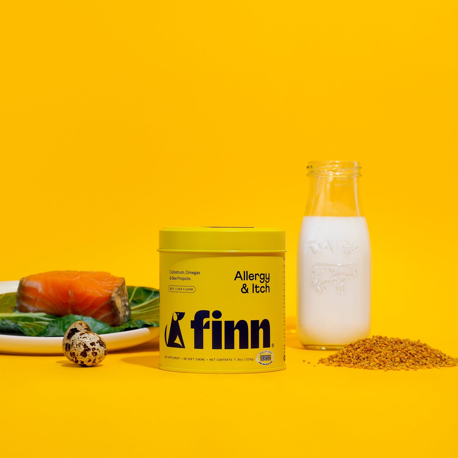 Yellow Finn Allergy & Itch supplement container with milk bottle, salmon, quail egg, and kibble on yellow background