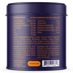 Purple cylindrical pet supplement container showing product facts label with active ingredients, vitamins, and dosage information for dogs.